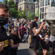 A protester holds a sign saying “check your racist-ass cop friends” near
